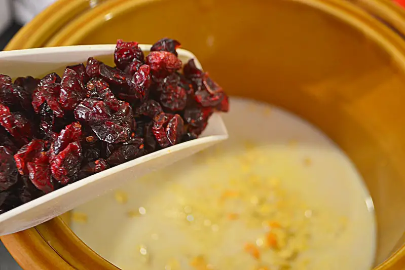 Dried cranberries in a white spoon